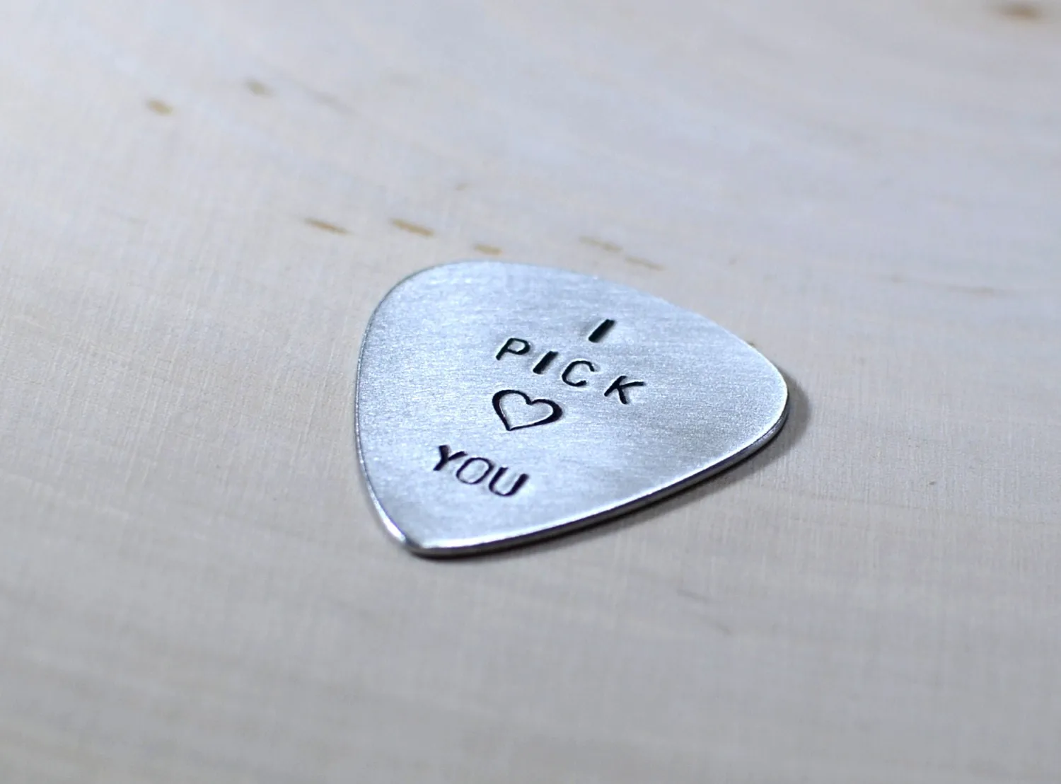 Aluminum I pick you guitar pick with a small heart design