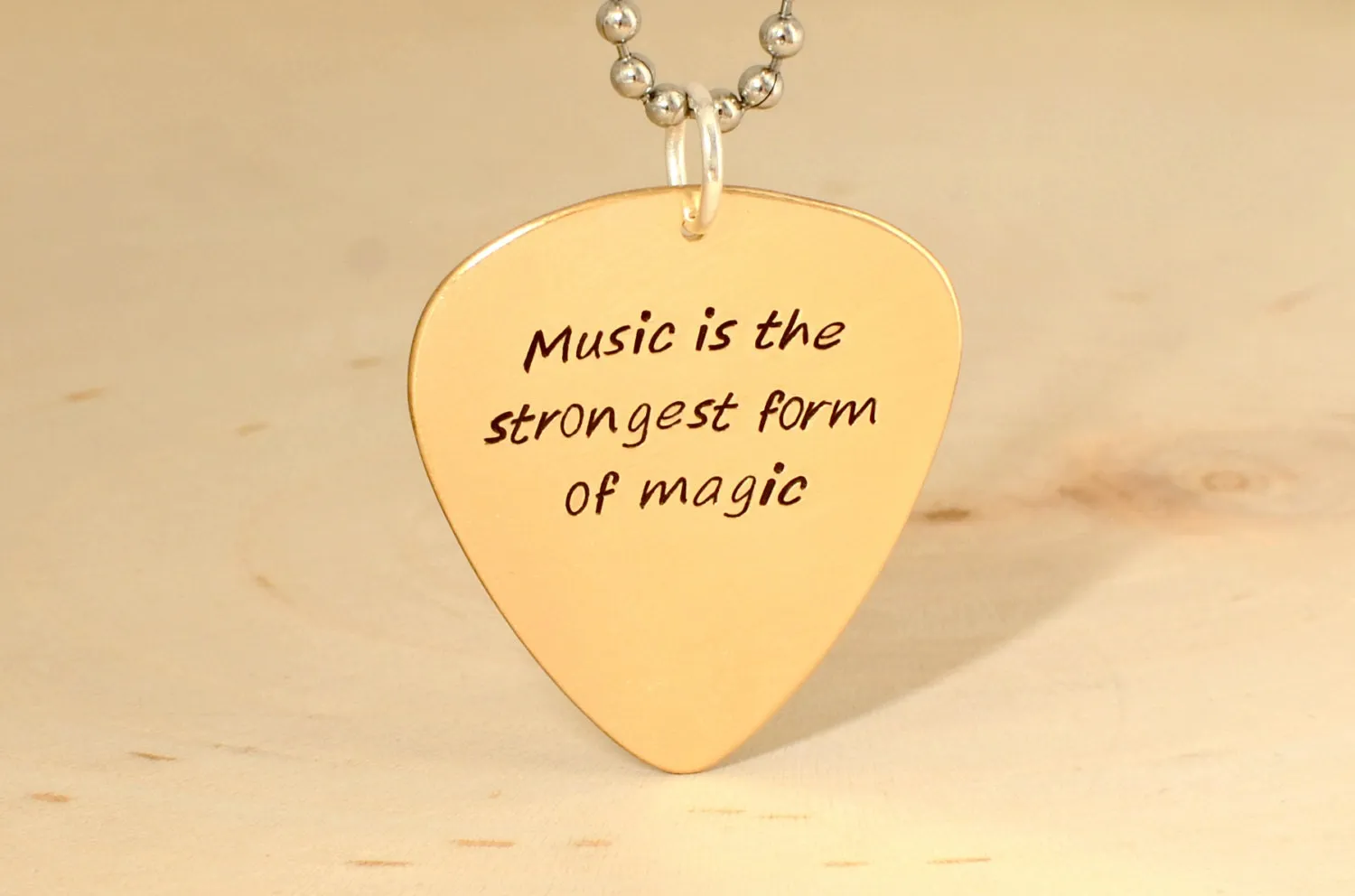 Bronze guitar pick necklace to engrave