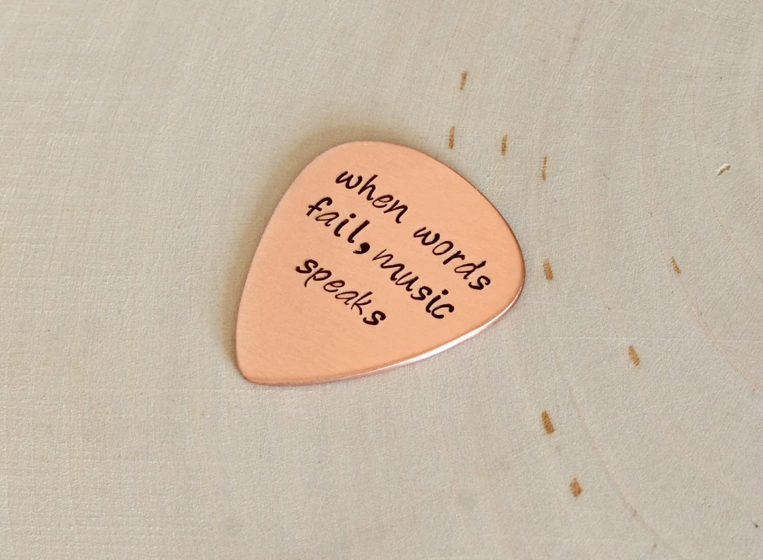 Guitar Pick with When Words Fail Music Speaks in Copper