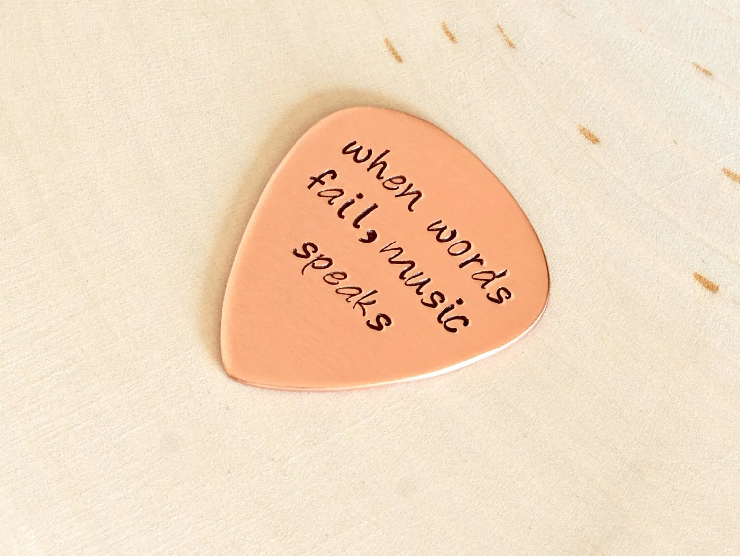 Guitar Pick with When Words Fail Music Speaks in Copper