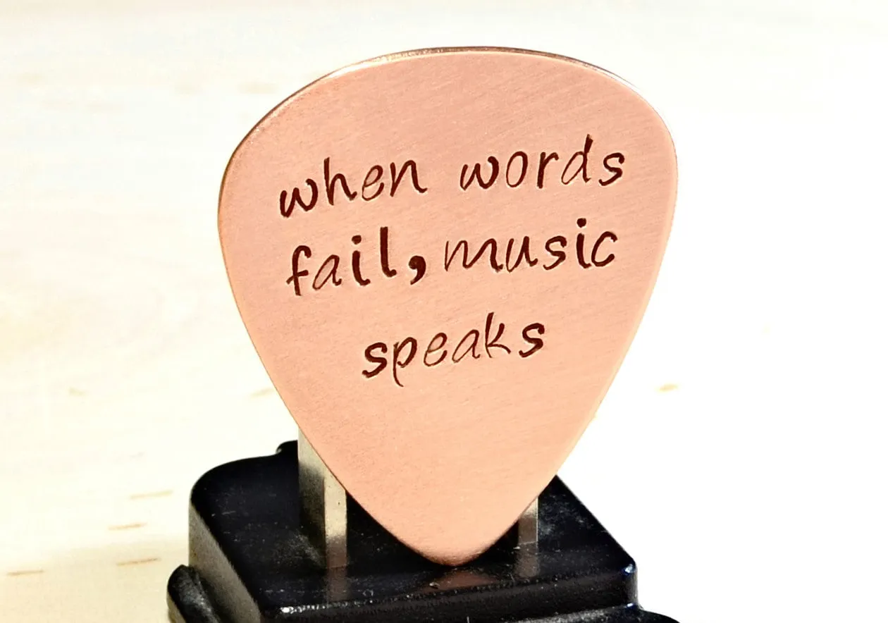 Guitar Pick with When Words Fail Music Speaks in Copper