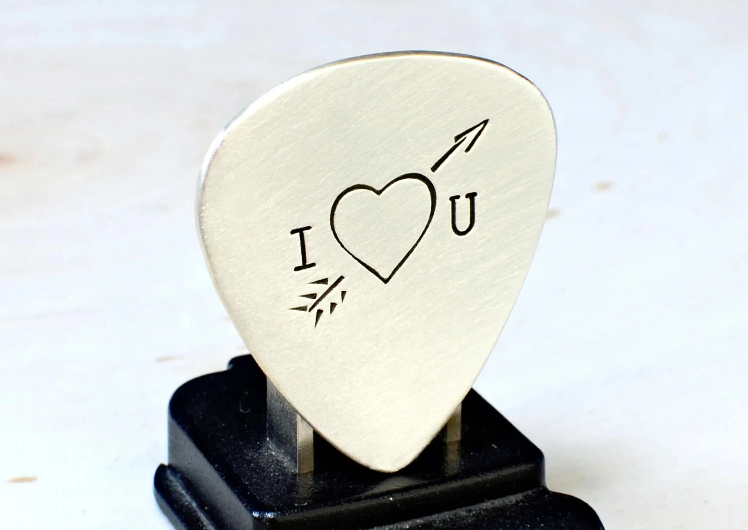 Heart and arrow theme on sterling silver guitar pick