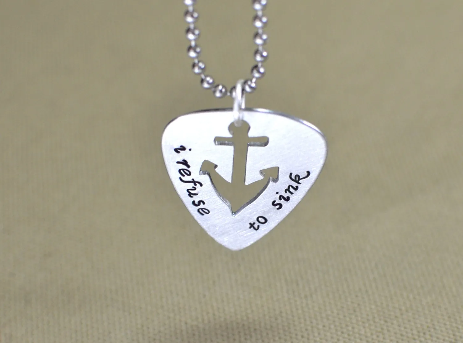 Refuse to sink guitar pick necklace with anchor design