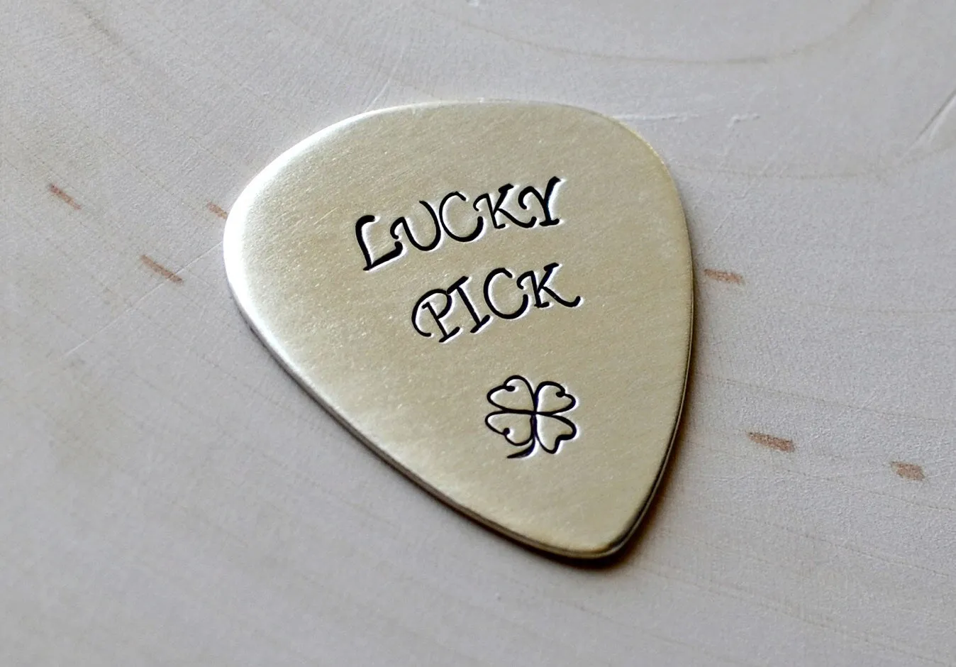 Sterling silver lucky guitar pick with four leaf clover