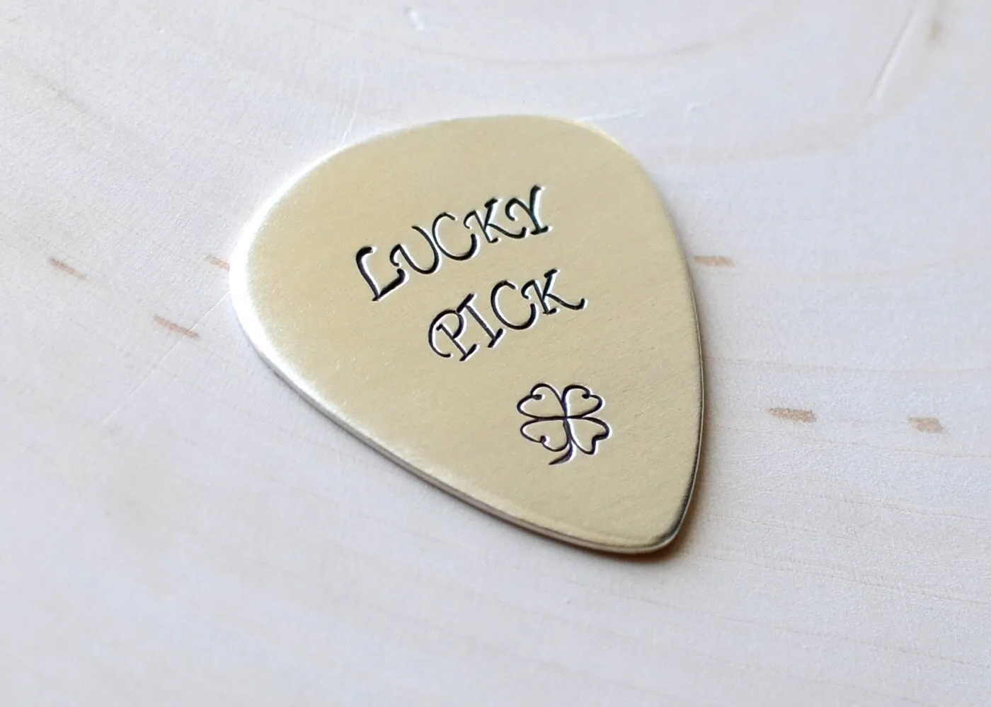 Sterling silver lucky guitar pick with four leaf clover