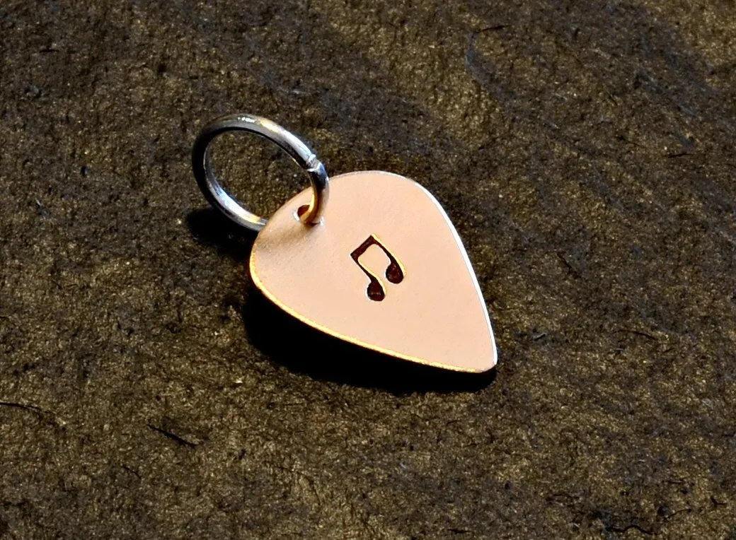 Tiny bronze guitar pick charm